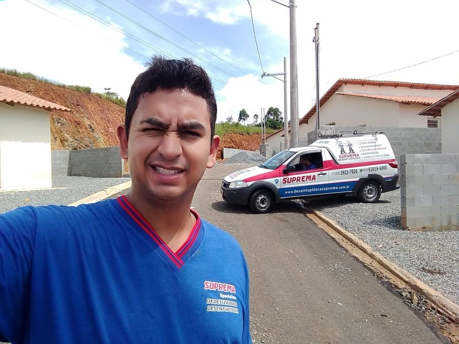 Técnico da Suprema ao lado do veículo da empresa em atendimento